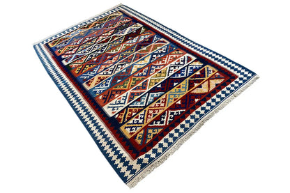 Square Kilim rug, rotated: bold red/blue ornaments with a white border.