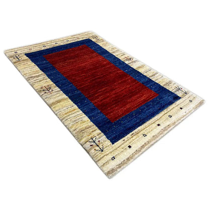 Beige gabbeh rug, red central rectangle in a dark blue border, geometric trim