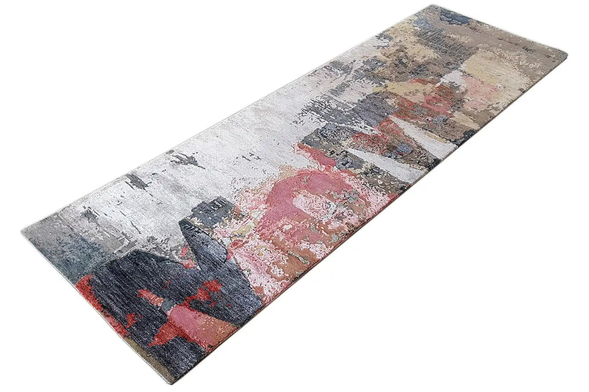 Rectangular rug with a vintage abstract pattern in gray, dark blue, red, and beige