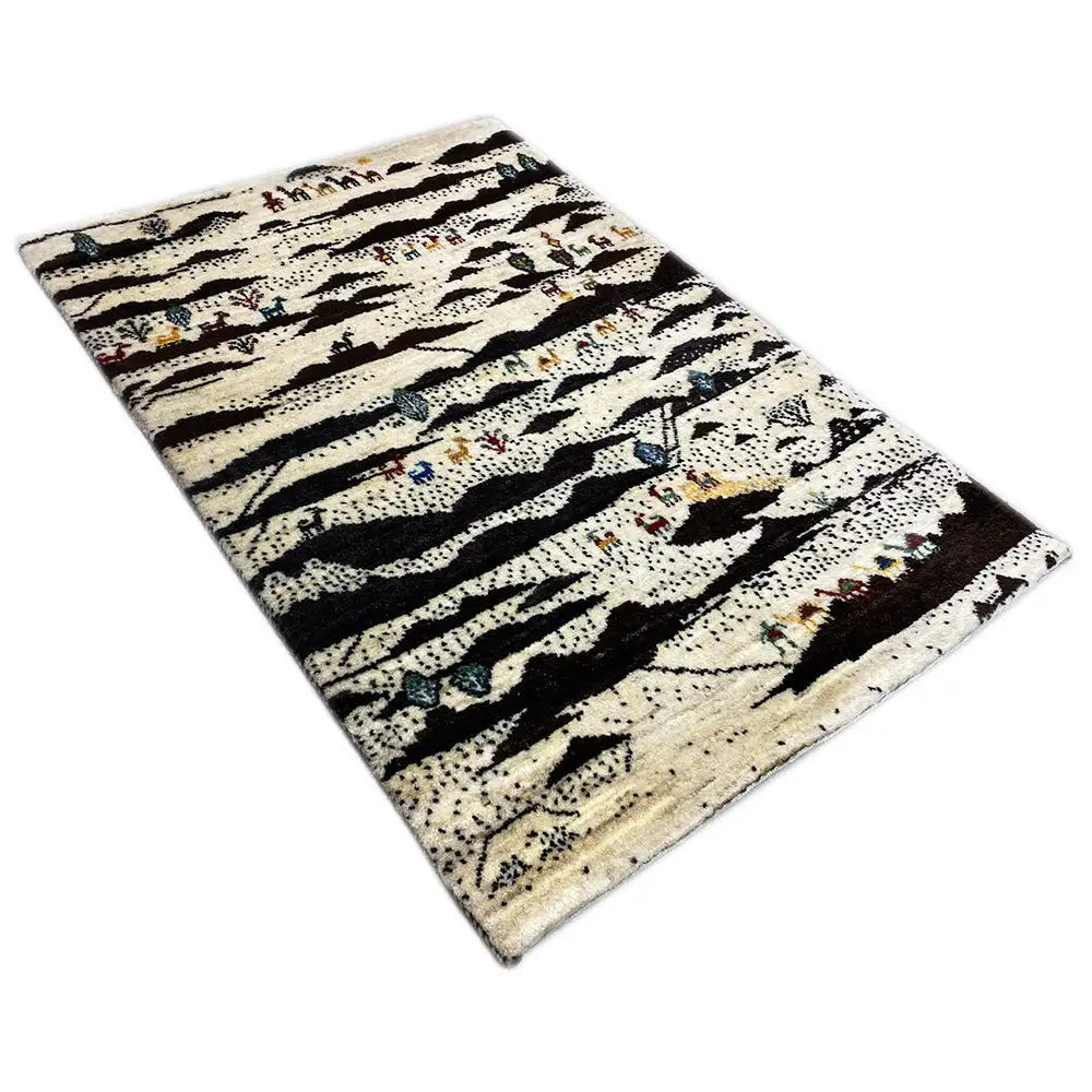 Gabbeh rug, laid diagonally, with a striped pattern in cream, black, and blue-red