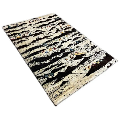 Gabbeh rug, laid diagonally, with a striped pattern in cream, black, and blue-red