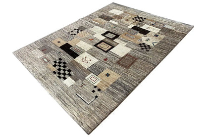 Carpet in an angled view with patchwork motifs in beige, gray, black, and small red details