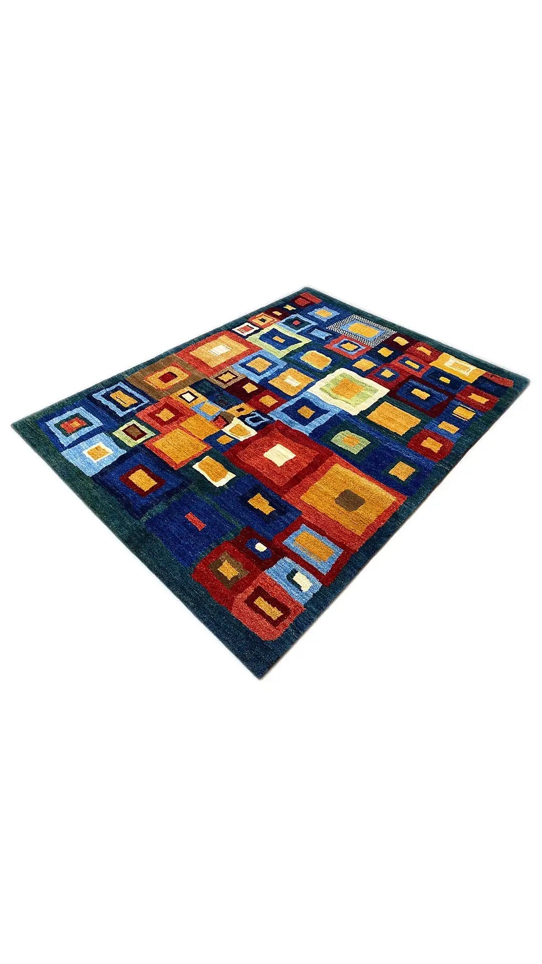 Gabbeh rug at an oblique angle, geometric squares in blue, red, yellow, and white.