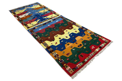 Rectangular kilim runner with colorful animal and landscape motifs, fringed edge