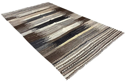 Dark brown kilim rug with light stripes and decorative border, diagonal