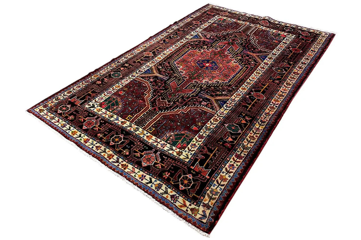 Dark red rug with patterned fields, a framed border, and colorful details
