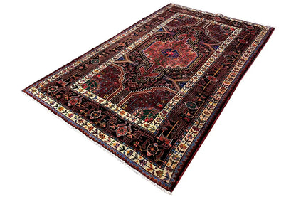 Dark red rug with patterned fields, a framed border, and colorful details