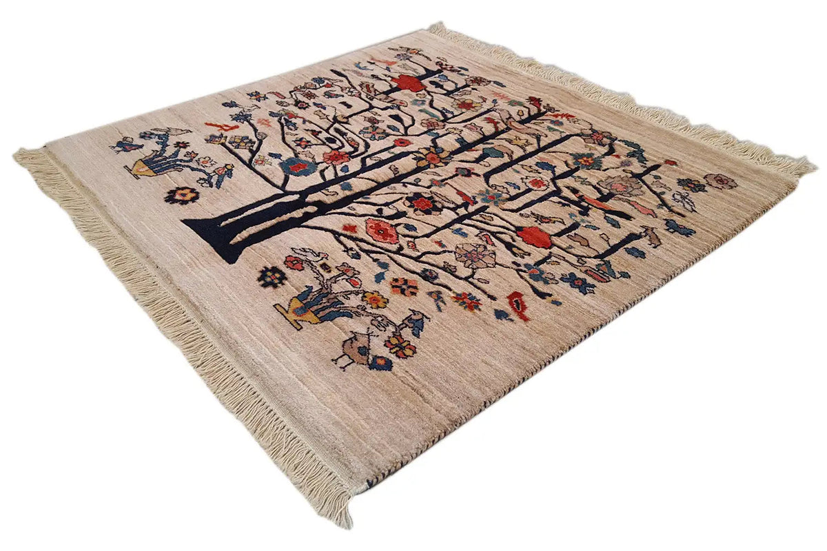 Beige rug with tree and medallion pattern, colorful ornaments, fringes.