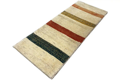 Gabbeh rug: diagonal view of the striped patterns in beige, red, and dark green