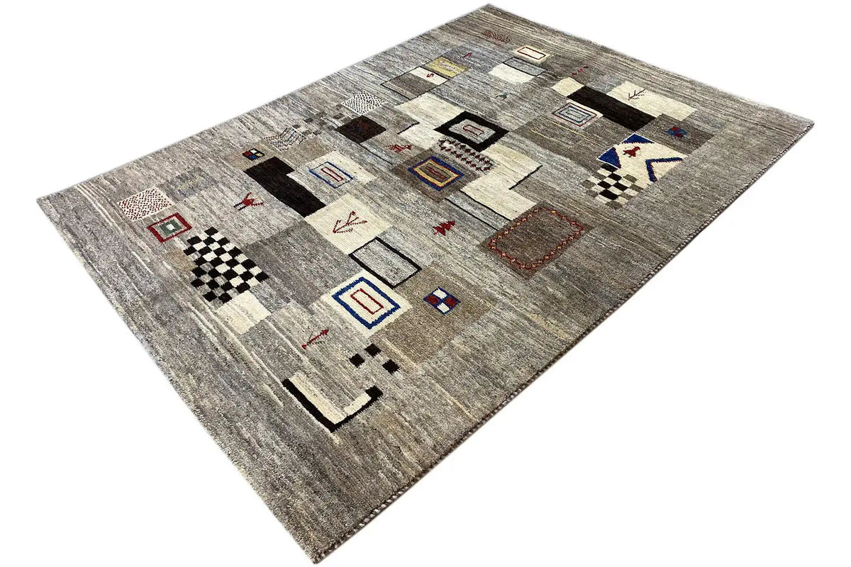 Gabbeh rug 210x150 cm photographed at an angle: gray surface with square and diamond patterns