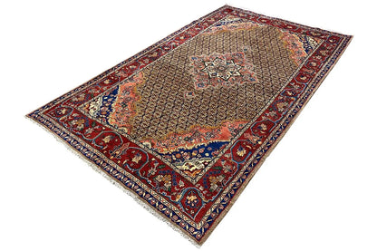 Rectangular oriental rug with a central medallion featuring floral motifs in brown and red