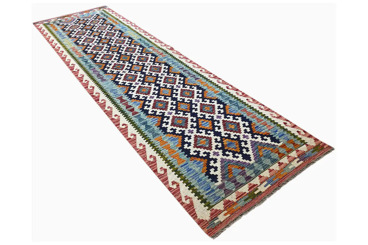 Slanted kilim runner: multicolored diamond and zigzag patterns with a colored border