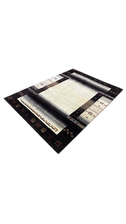 Gabbeh rug in a diagonal composition: beige center, dark border, and small colorful patterns