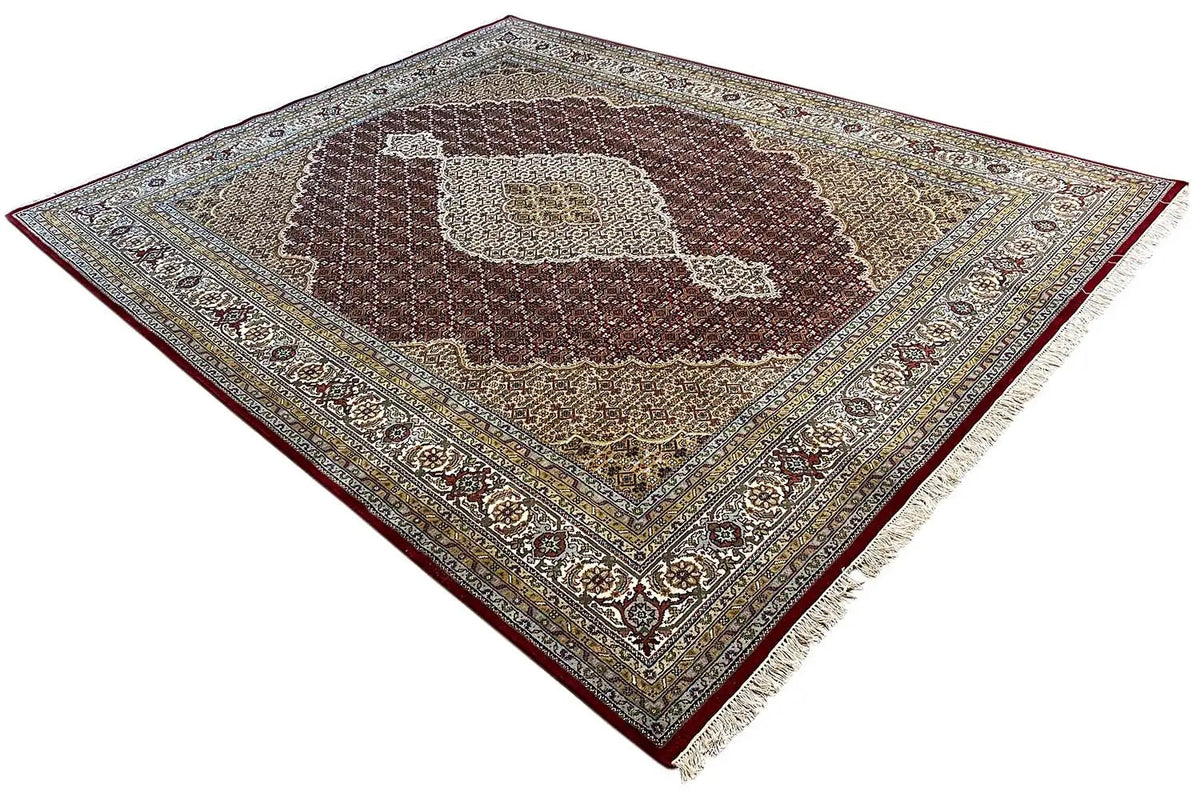 Indo Tabriz rug in diagonal view, medallion and ornamental border in brown/beige