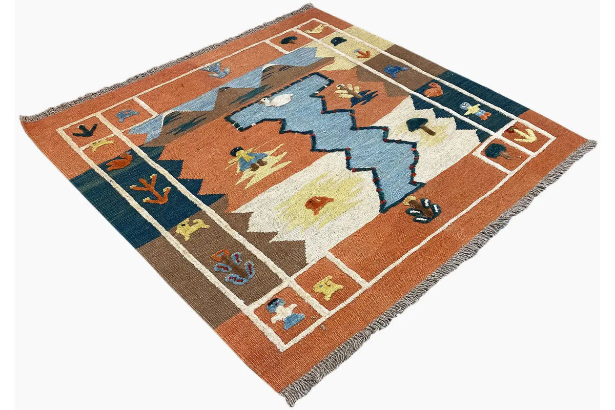 Kilim rug viewed at an angle: geometric shapes in brown, blue, and yellow, with fringes