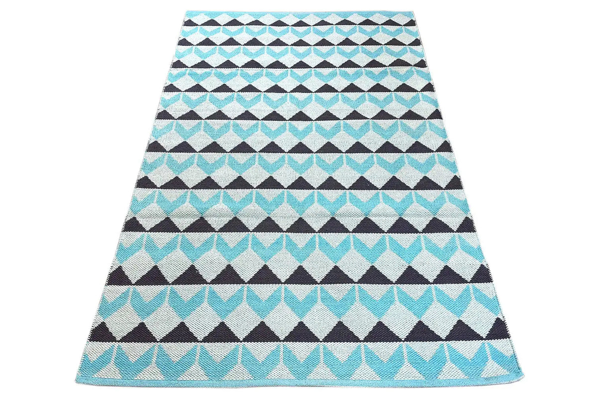 Carpet in a diamond and zigzag pattern; view of the width with a turquoise border band