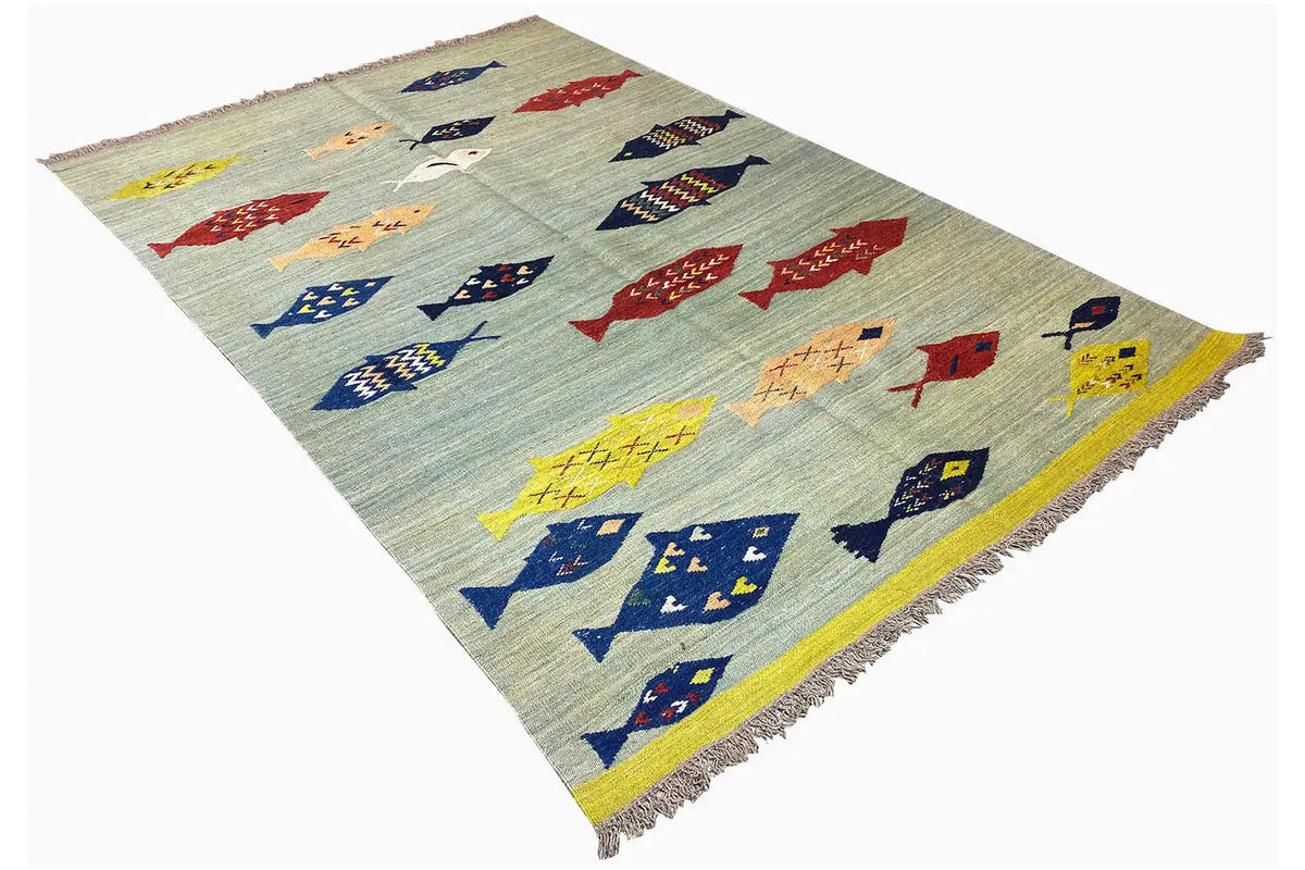 Kelim in angled view: fish motifs in red, blue, and yellow on a light blue background