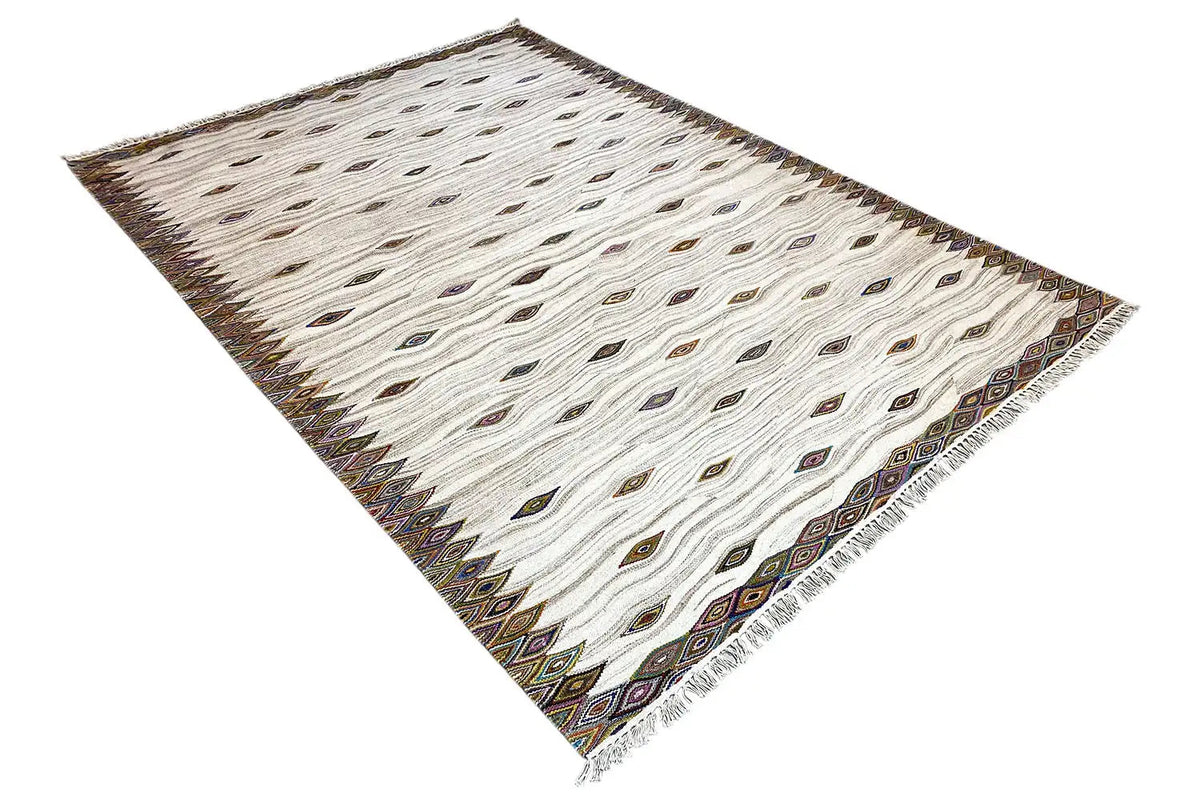 Kilim dhurrie rug laid diagonally, cream with diamonds and a dark brown border
