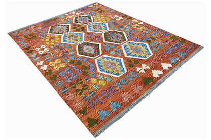 Geometrically patterned kilim with diamond and hexagon motifs in orange, blue, and turquoise