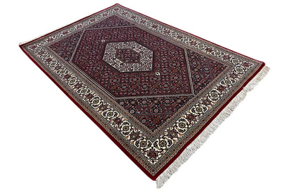 Oriental rug Bidjar: diagonally aligned pattern in dark red with cream-colored borders