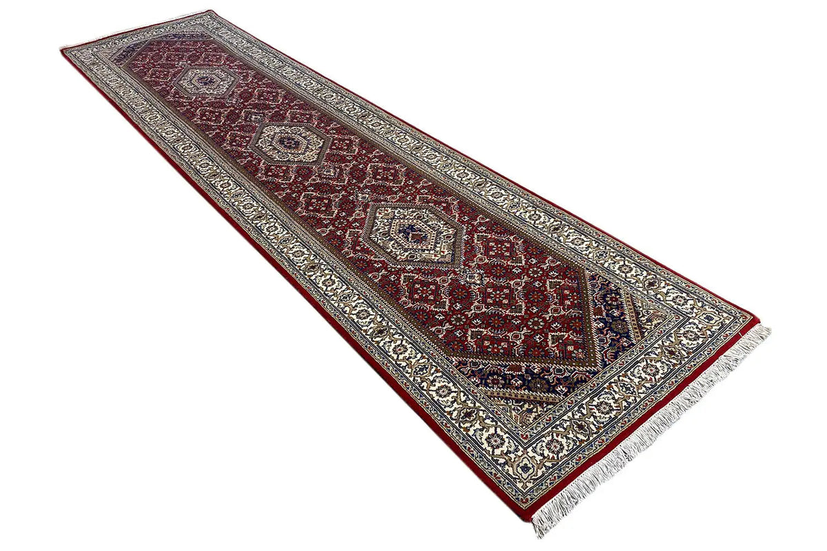 Narrow, long Bidjar runner with a red field and blue-beige medallion border