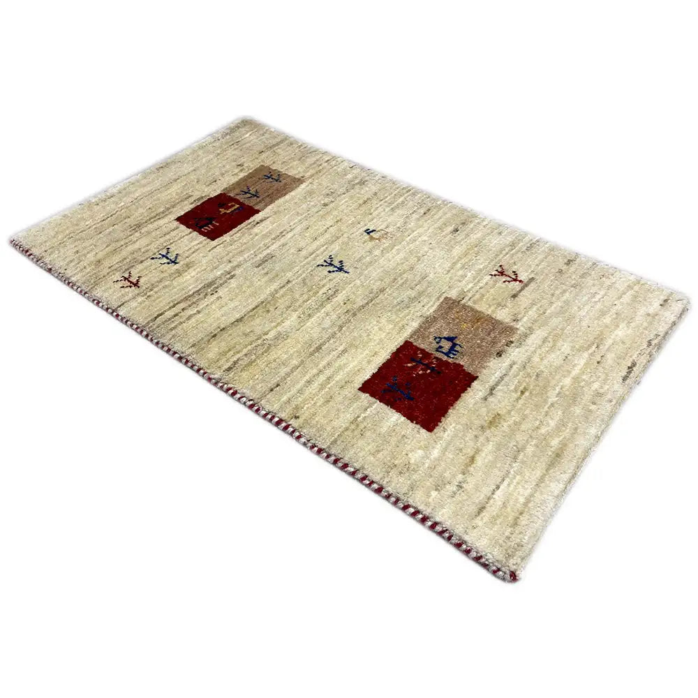 Gabbeh rug with a beige background, decorative fields in red and blue, and a fine woven pattern