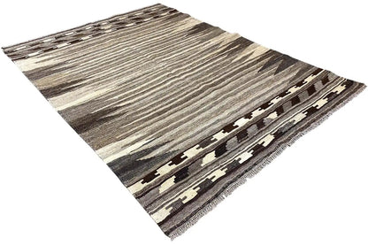 Kilim rug corner in an angled view with a geometric border