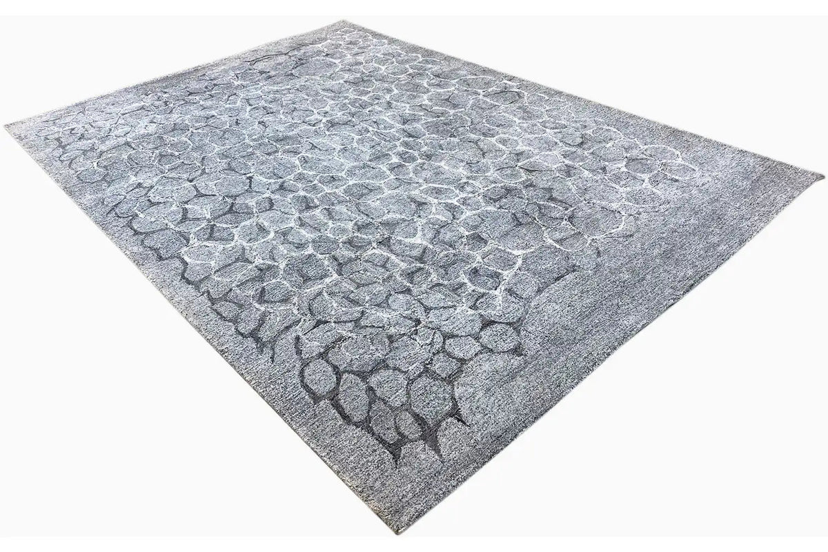 Hand-tufted rug, light blue-gray scale pattern, diagonal top view