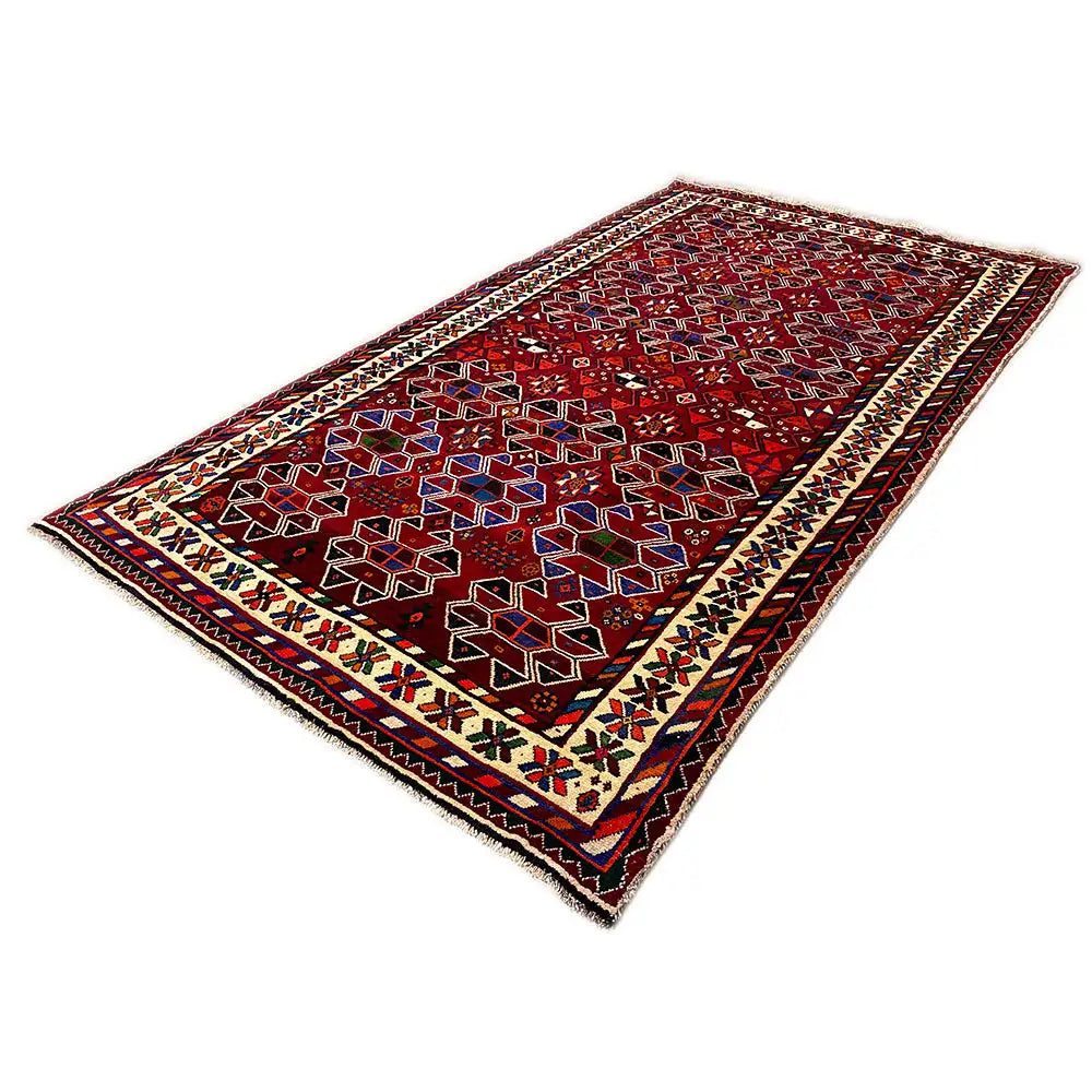 Shiraz rug, lying flat, red pattern with a colorful border and fringes