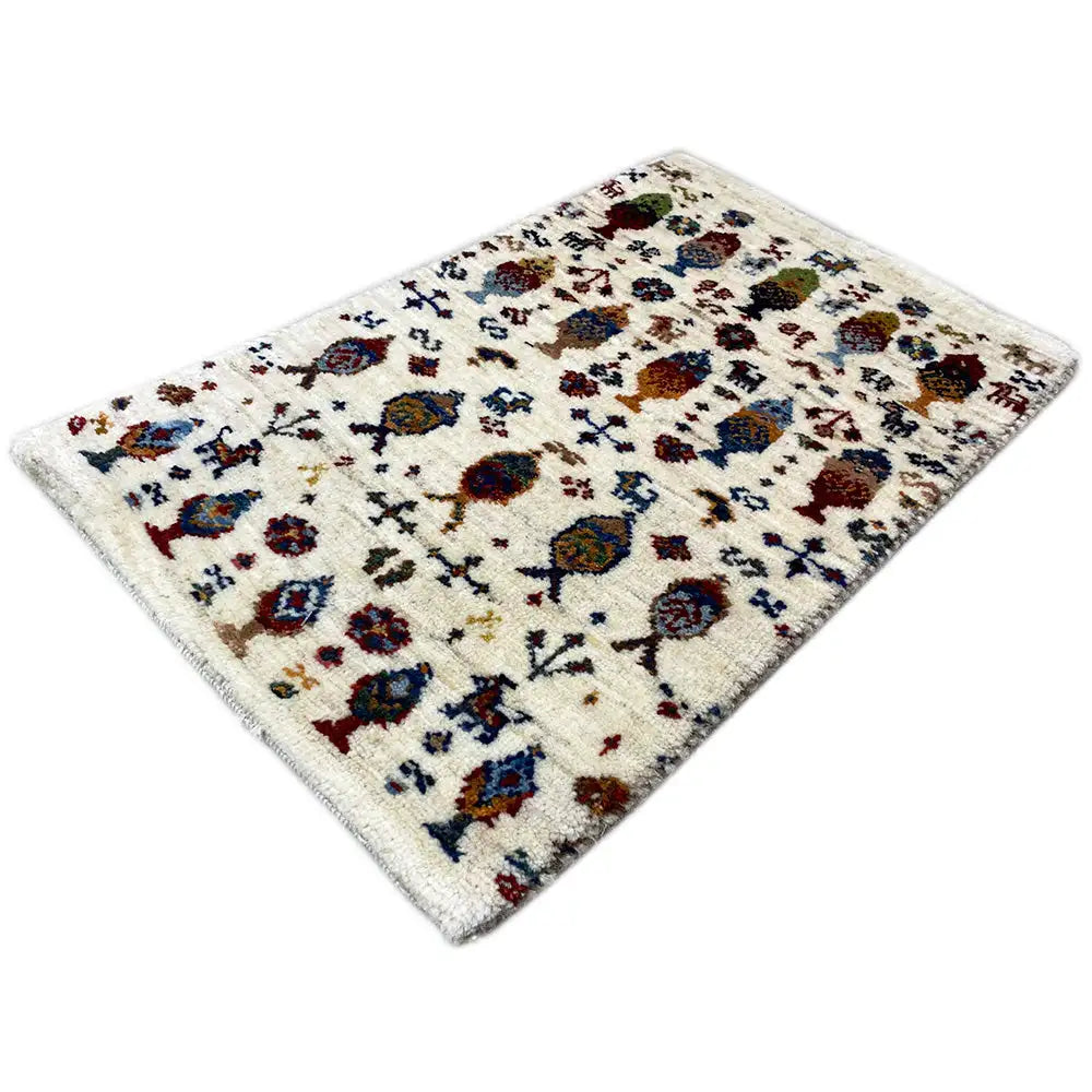 Gabbeh rug 58x37 cm laid out diagonally, cream-colored with colorful figurative ornaments.