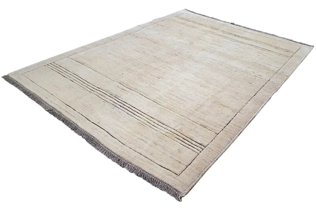 Gabbeh rug in a beige tone with a diagonal view, layered lines, and fringes