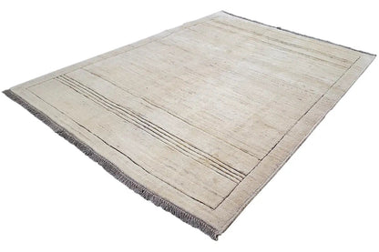 Gabbeh rug in a beige tone with a diagonal view, layered lines, and fringes
