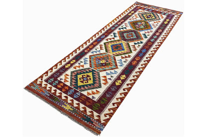 Afghan kilim runner with a colorful geometric pattern in blue, red, and cream