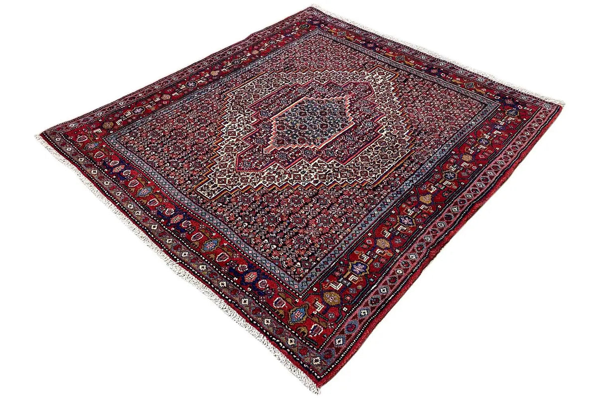 Diamond-cut rug, red ground with a central medallion and borders