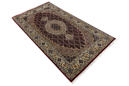 Top-view rug: large medallion, dark border, and delicate ornamental pattern in brown