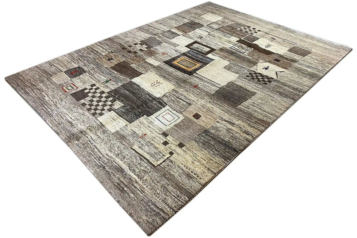 Gabbeh rug in three-quarter view, beige-gray all-over pattern with dark accents
