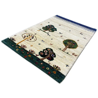 Gabbeh rug with a beige pile and animal and tree motifs; dark green border.