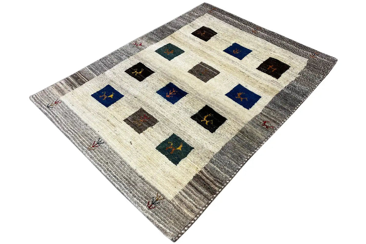 Gabbeh rug with geometric squares in blue and black on a cream background