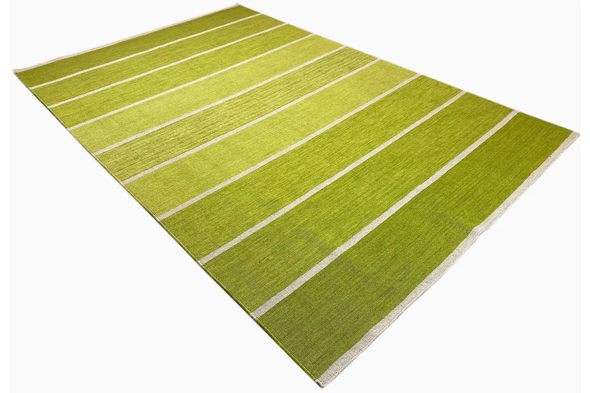 Kilim rug with a diagonal view: green surface and light stripes, uniform coloring