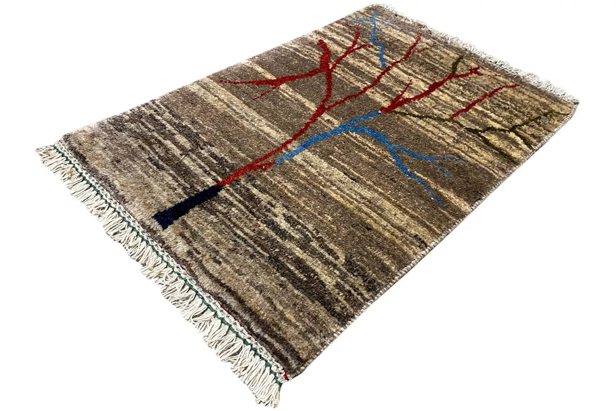 Carpet diagonally patterned with a red-and-blue tree ornament on a brown-and-beige striped pattern, fringes