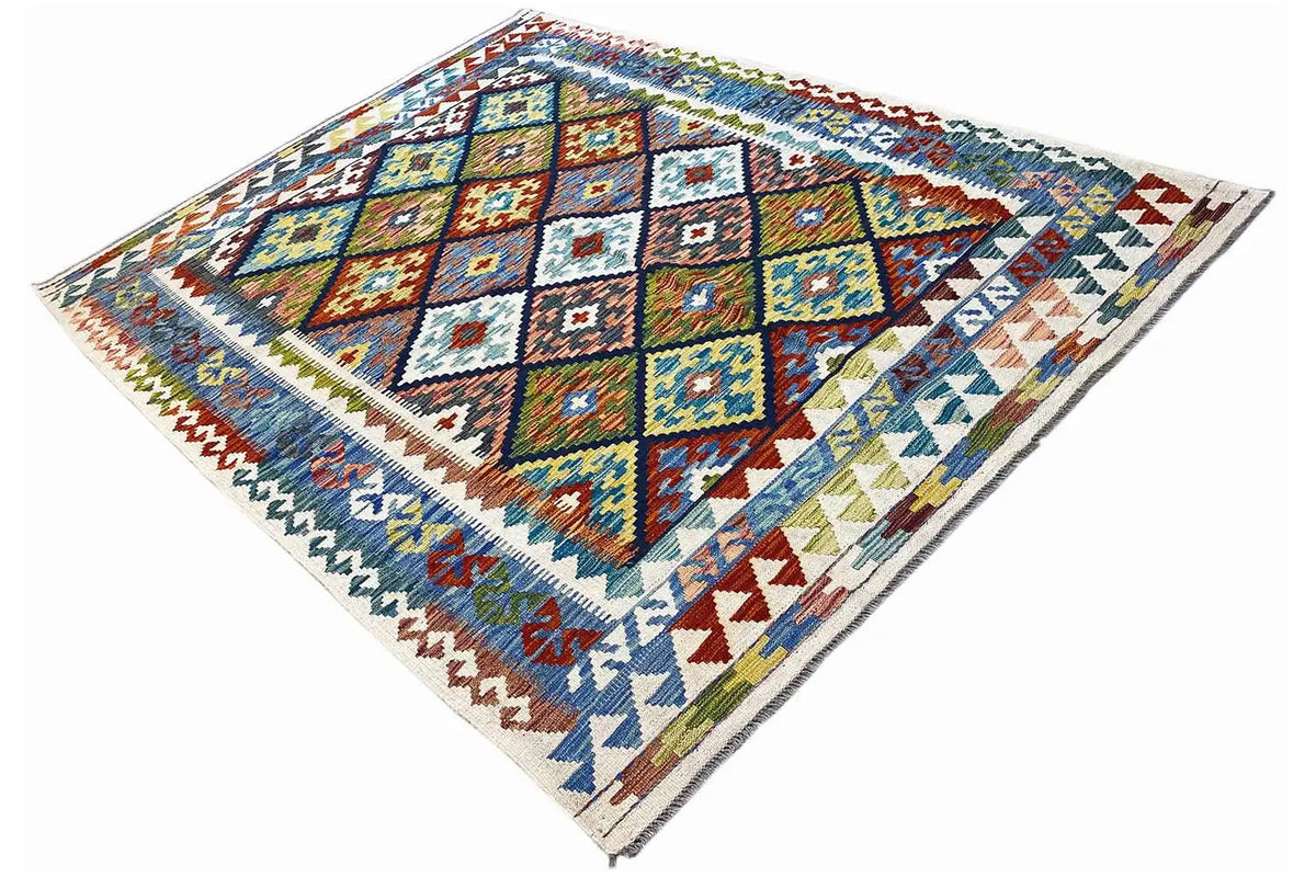 Afghan kilim with a large diamond medallion and zigzag border in blue, yellow, and reddish brown