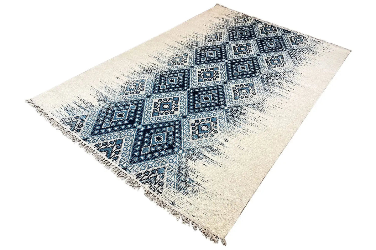 Kelim dhurrie rug placed at an angle, light-colored pattern with blue ornament and fringes
