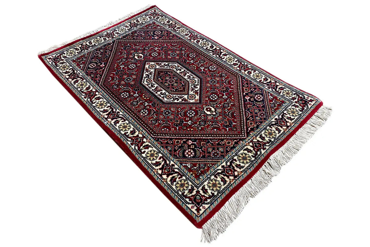 Carpet (92x60 cm) diagonal: red central medallion, fine ornamental borders, fringes