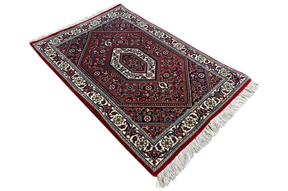 Carpet (92x60 cm) diagonal: red central medallion, fine ornamental borders, fringes