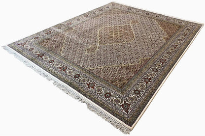 Rug with a central medallion, dark-accented border, fringed edges