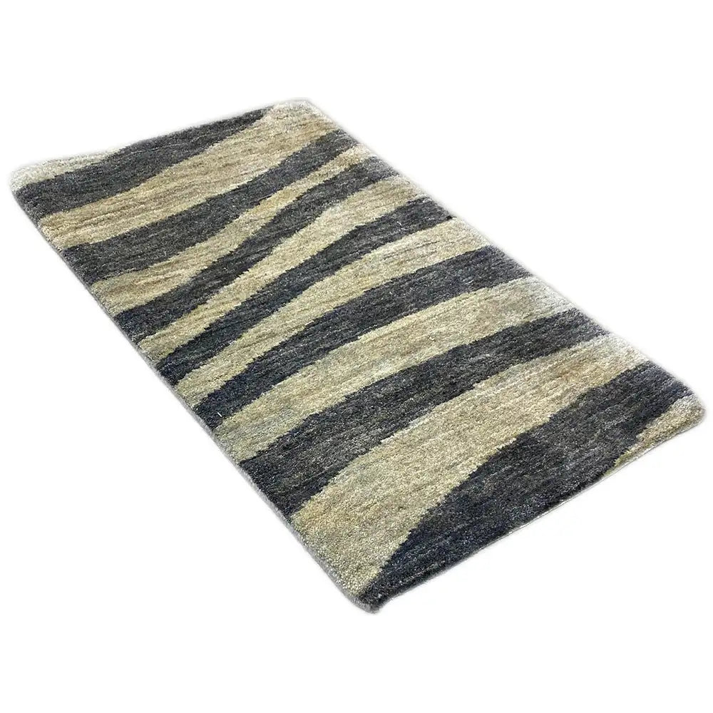 Striped rug with diagonal lines in blue-gray and beige, low pile