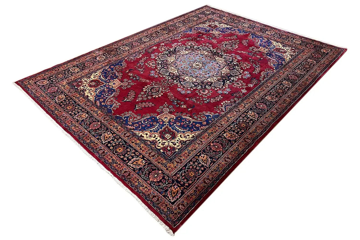 Rug with a red medallion in a dark blue and brown border, symmetrical ornament
