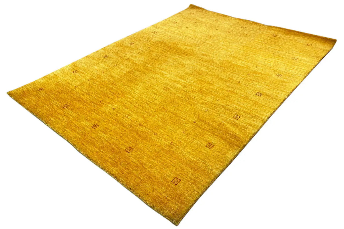 Gabbeh rug 185x138 cm: yellow rug, angled view, square accent patterns