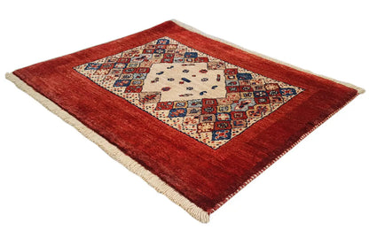 Oriental rug 74x60 cm with a red border, central medallion, and fringes