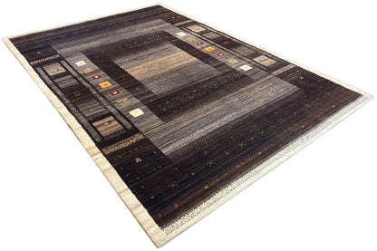 Gabbeh rug, shown at an angle: dark brown and gray areas with a framed border pattern